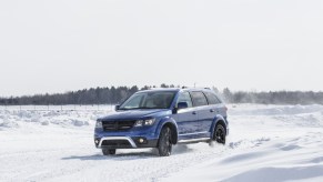 A blue 2020 Dodge Journey driving through snow
