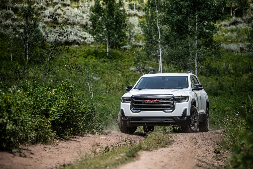 A white 2020 GMC Acadia AT4 parked on a dirt trail
