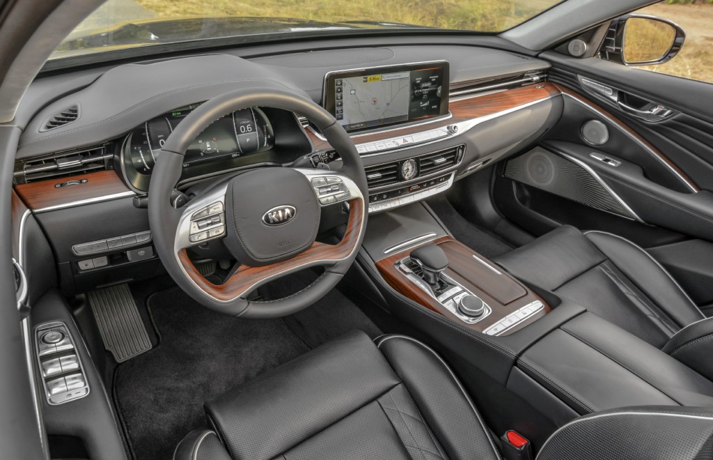 A close-up look at the interior of the 2020 Kia K900 with leather seats and wood trim