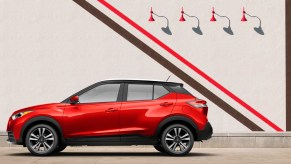 A red 2020 Nissan Kicks parked next to an artsy wall