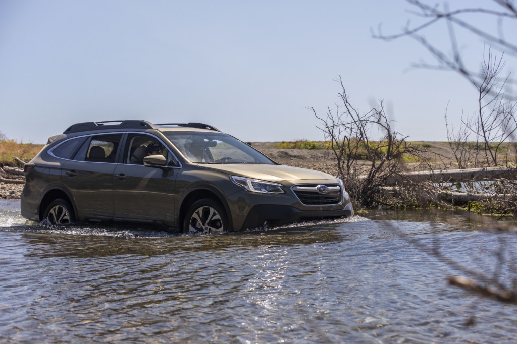 A 2020 Subaru Outback with AWD driving through water
