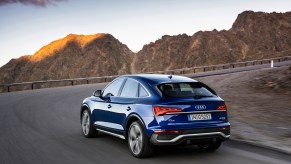 A 2021 Audi Q5 Sportback in Ultra Blue (European model) traveling around a curve on a mountain road