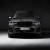 An image of a 2021 BMW X7 in a dark studio.