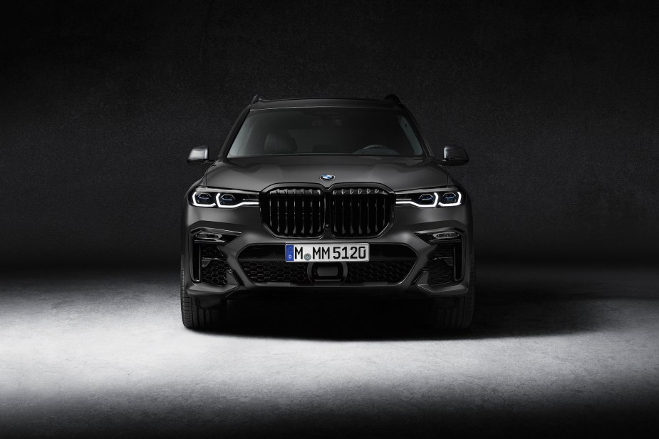 An image of a 2021 BMW X7 in a dark studio.