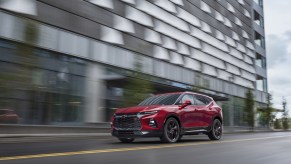 A red 2021 Chevrolet Blazer driving down a city road