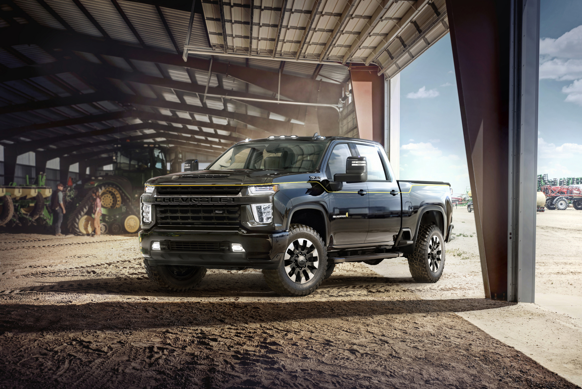the 2021 chevrolet silverado 3500HD parked in the sand in a large barn