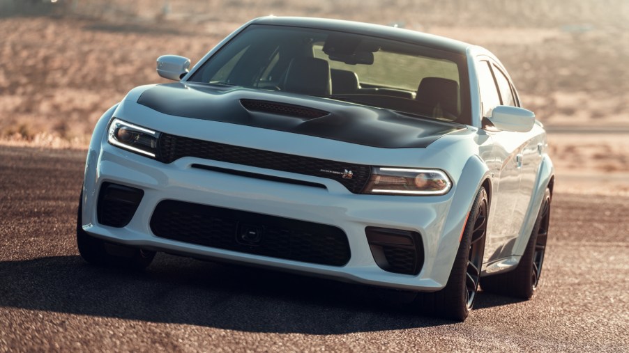 A white and black 2021 Dodge Charger driving on a track