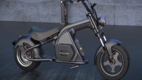 This gunmetal and black electric scooter looks like a motorcycle chopper.