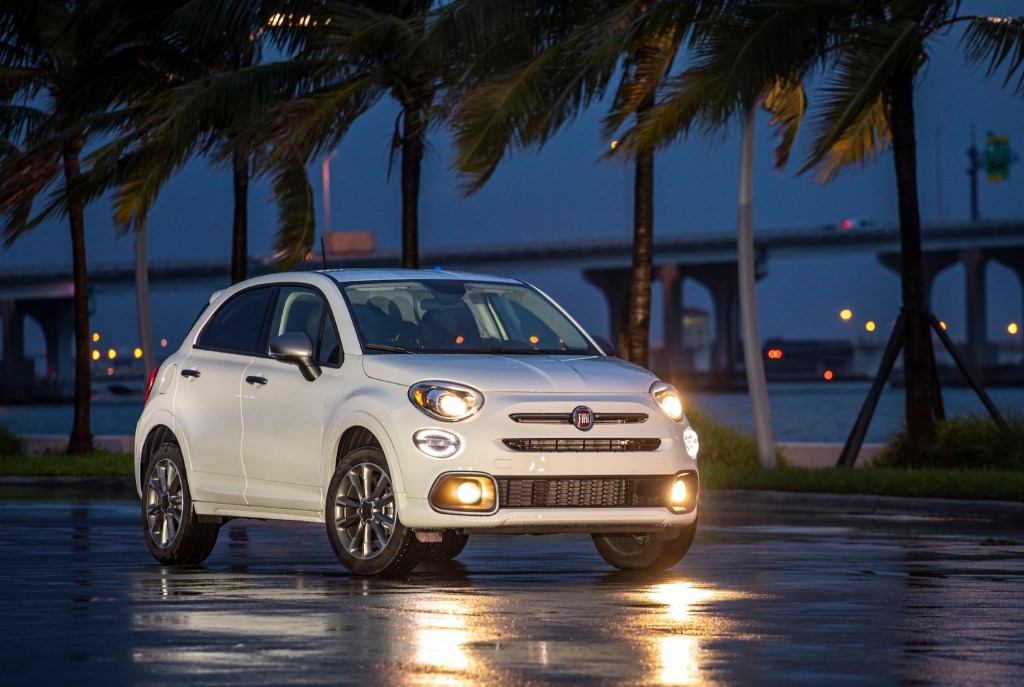 A white 2021 Fiat 500X Pop with Sport Appearance Package sits on wet pavement overlooking Biscayne Bay in Miami, Florida