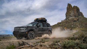 A 2021 Ford Bronco Sport Outer Banks in Carbonized Gray drives through a desert