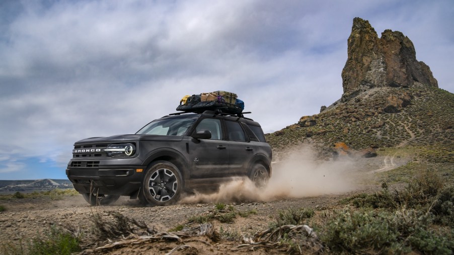 A 2021 Ford Bronco Sport Outer Banks in Carbonized Gray drives through a desert