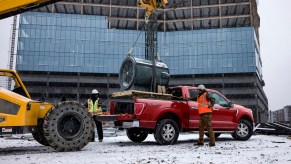 A dark-red 2021 Ford F-150 on a construction site