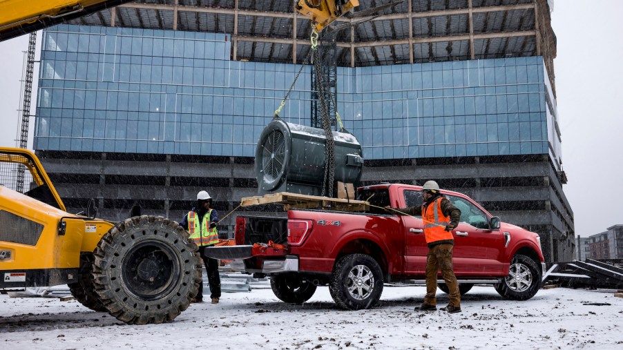A dark-red 2021 Ford F-150 on a construction site