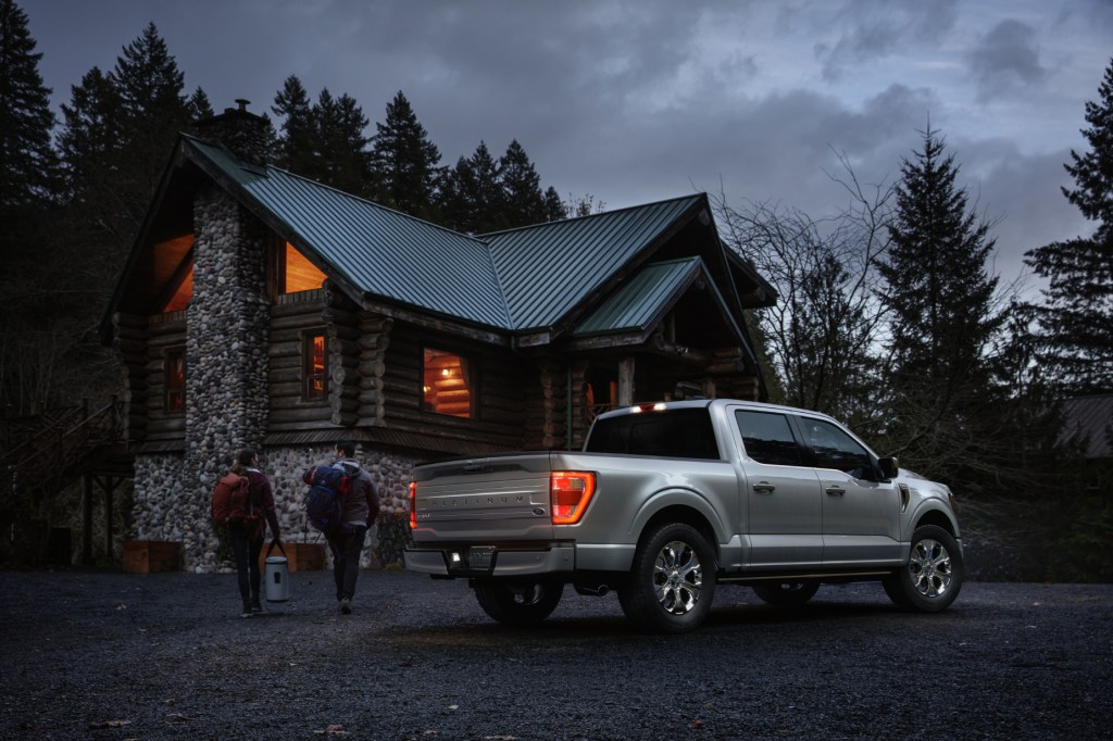 A silver 2021 Ford F-150 Platinum parked in front of a country house