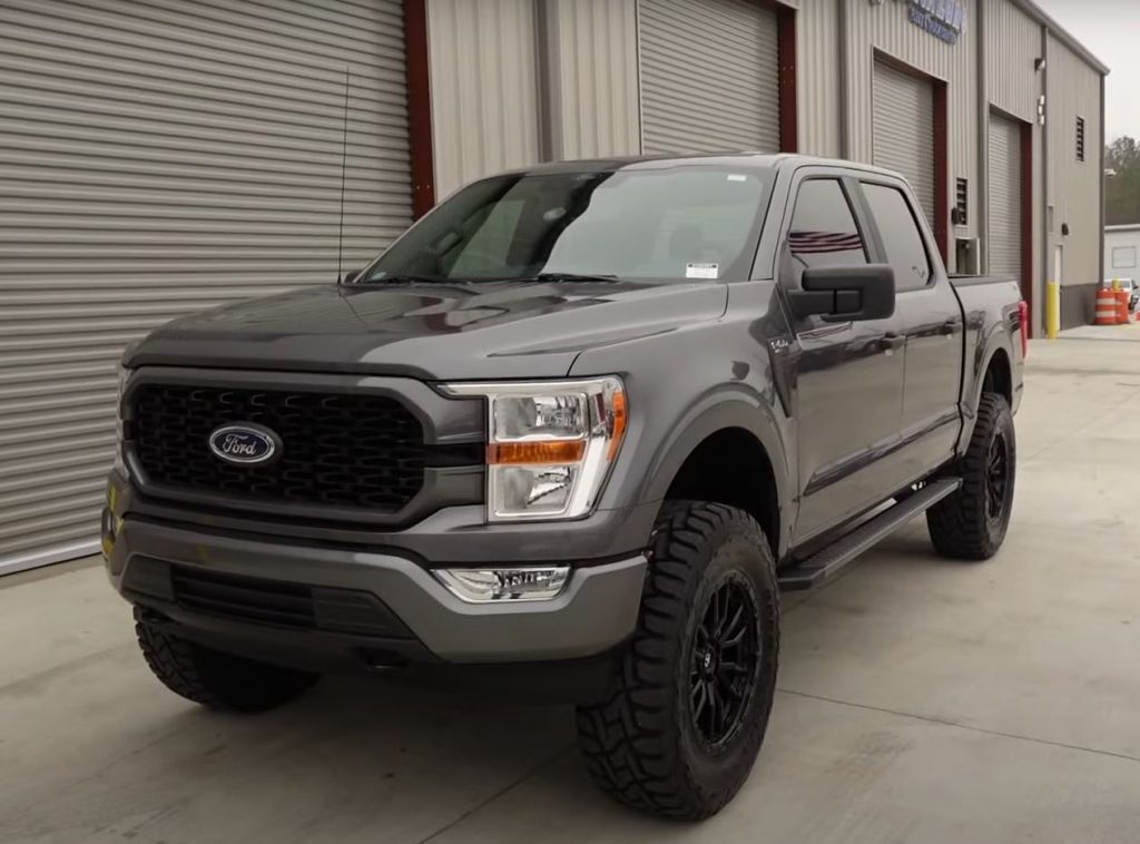 A carbonized gray 2021 Ford F-150 SuperCrew with a 6-inch lift and 37-inch tires