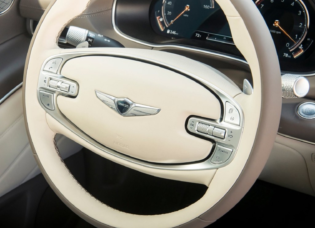 The 2021 Genesis GV80's white-and-brown 2-spoke steering wheel
