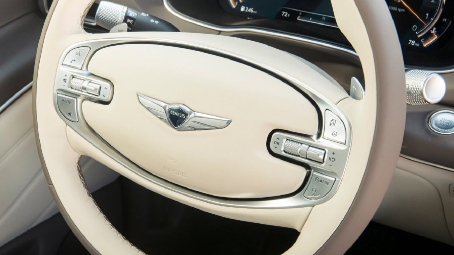 The 2021 Genesis GV80's white-and-brown 2-spoke steering wheel