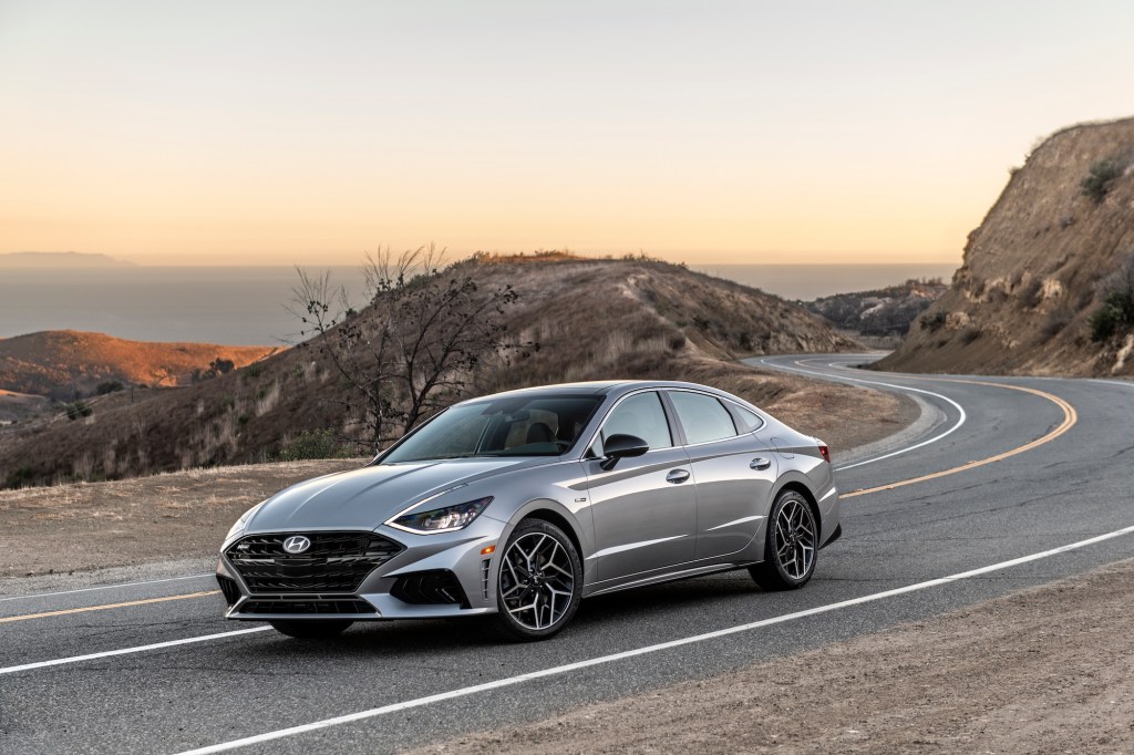 a gray 2021 hyundai sonata driving on a winding mountain road