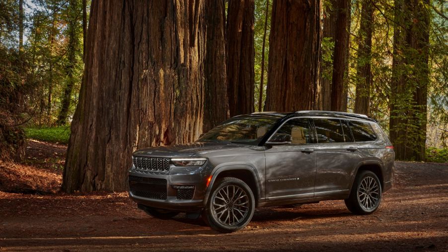 A gray 2021 Jeep Grand Cherokee L Summit Reserve in a forest