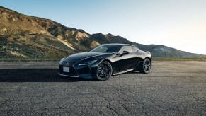 The all-black 2021 Lexus LC 500 Inspiration Series parked on pavement in front of mountains