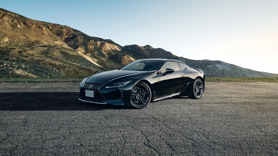 The all-black 2021 Lexus LC 500 Inspiration Series parked on pavement in front of mountains
