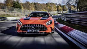 An orange 2021 Mercedes-AMG GT Black Series driving on a track