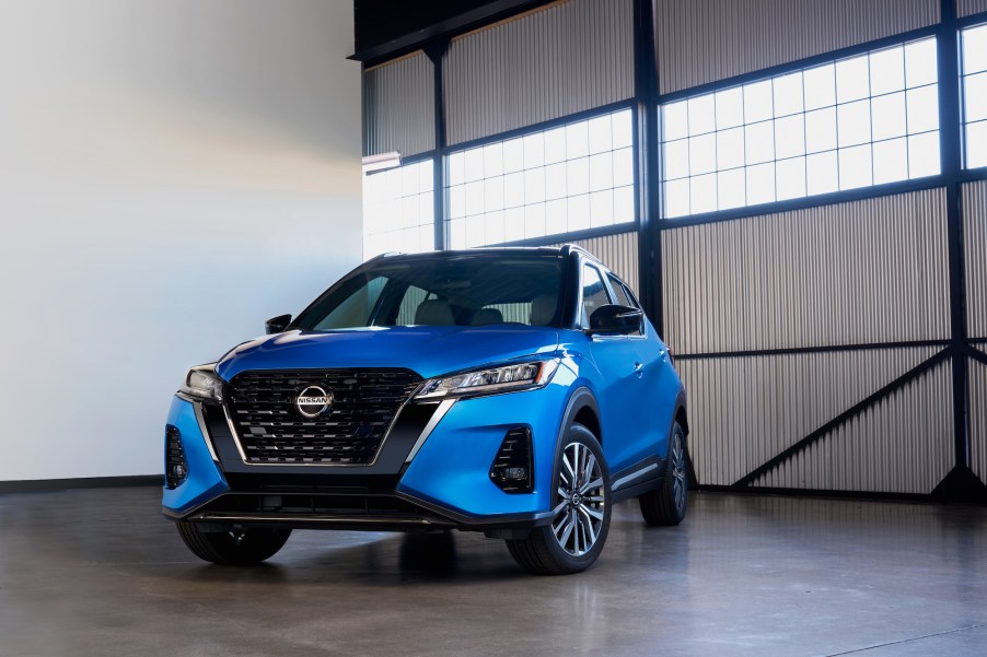 A blue 2021 Nissan Kicks subcompact crossover SUV parked in a bare garage