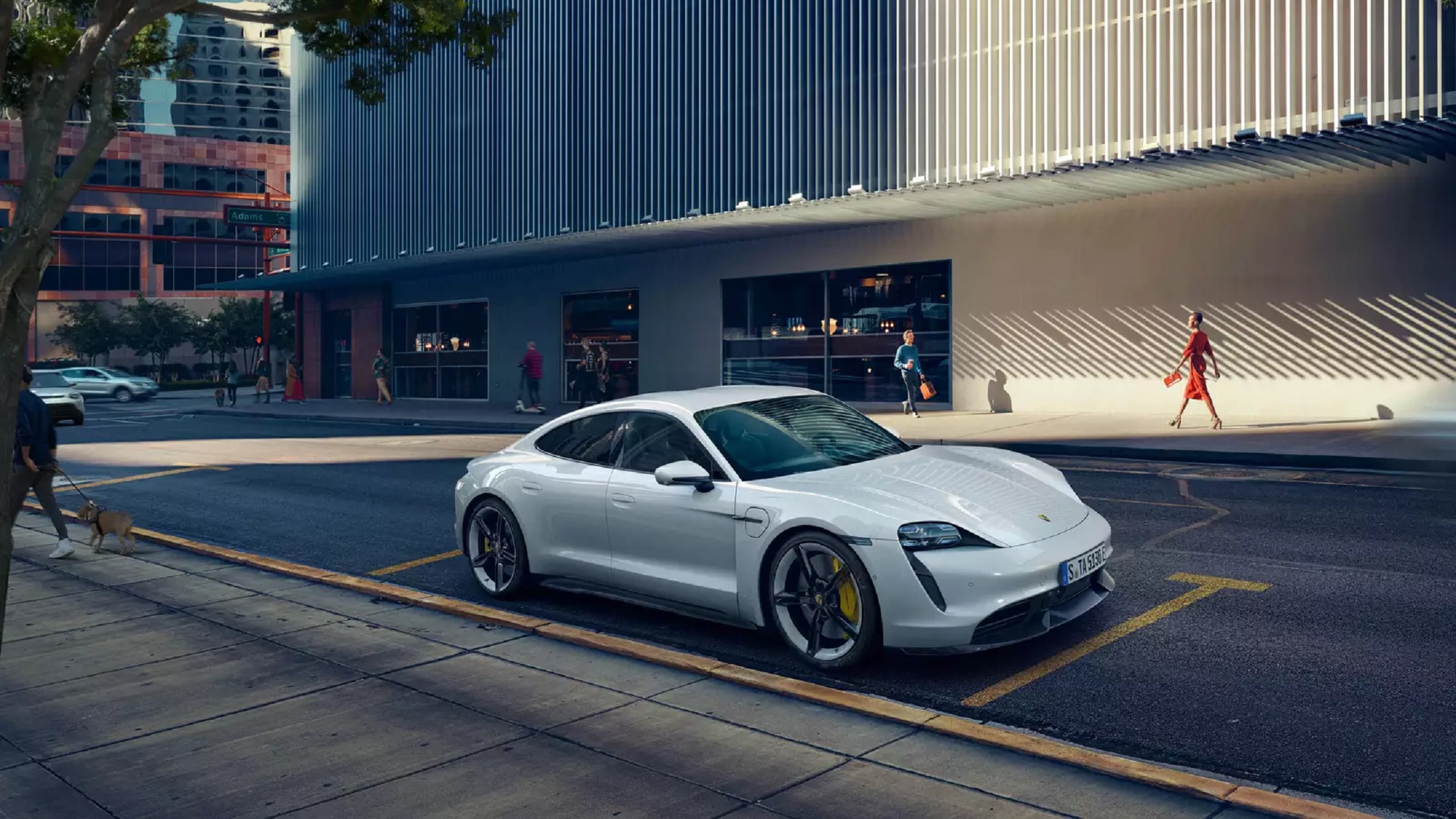 A white 2021 Porsche Taycan Turbo S parked on a city street