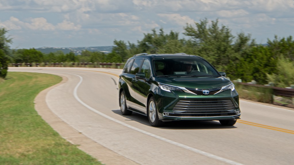 A green 2021 Toyota Sienna driving down a road
