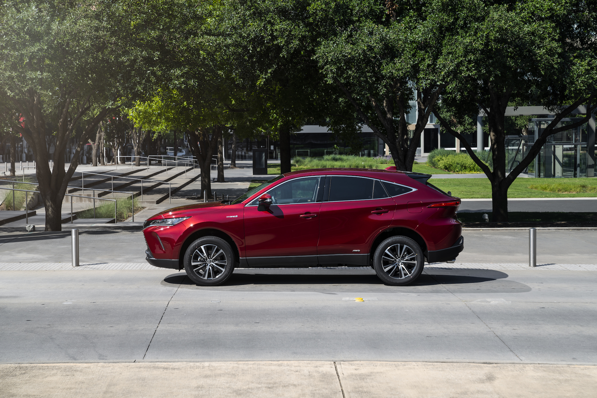 A dark-red 2021 Toyota Venza LE stopped on a city street