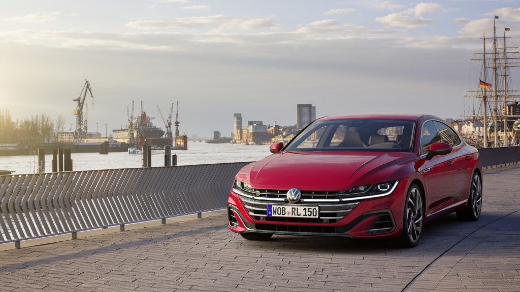 A red 2021 Volkswagen Arteon driving down a highway road