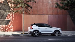A white 2021 Volvo XC40 parked in front of an orange building