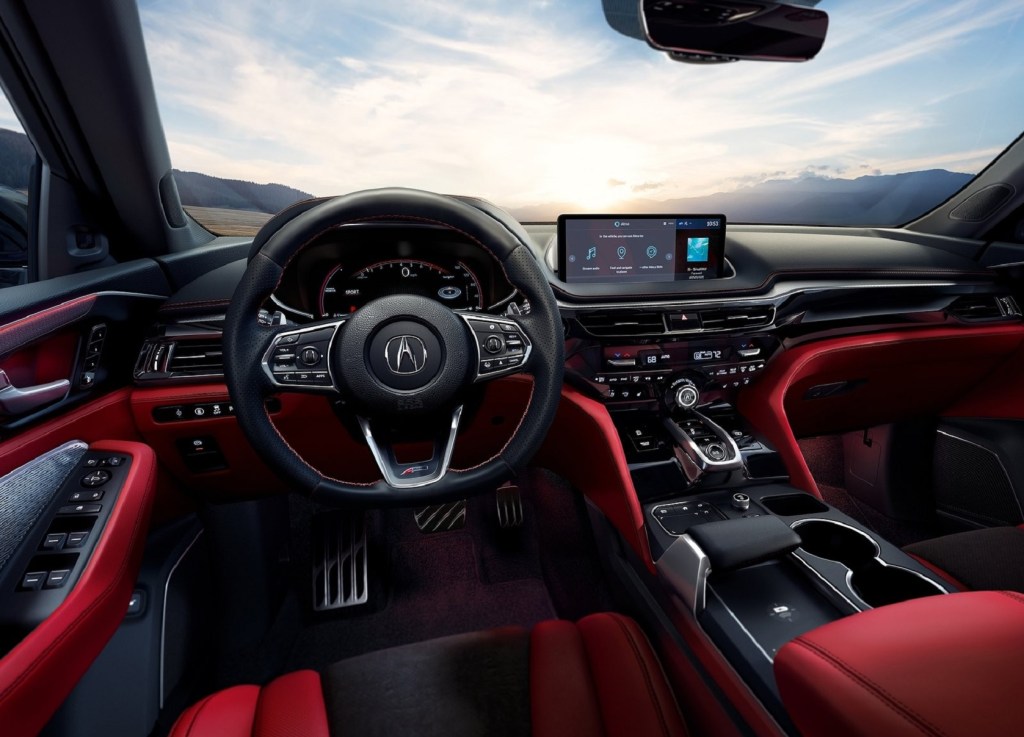 The red-leather front seats and black dashboard of the 2022 Acura MDX A-Spec