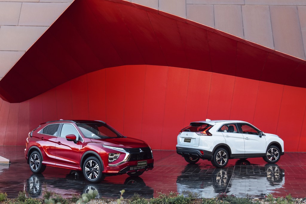 A couple of 2022 Mitsubishi Eclipse Cross compact SUVs on display, one red and one white