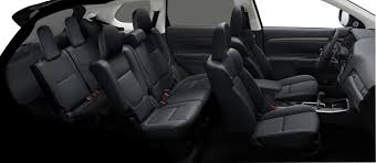 Sideview of a used Toyota Highlander with black upholstery. 