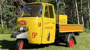 A modified yellow Coca-Cola-liveried 1980 Piaggio Ape