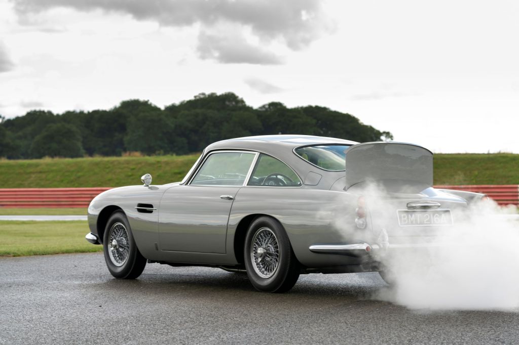 The rear view of a silver Aston Martin DB5 Goldfinger Continuation with its smokescreen and bullet-resistant shield deployed