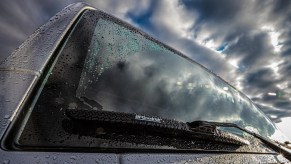 BFGoodrich Off-Road Wiper blades on a rain-streaked gray-blue Jeep Wrangler
