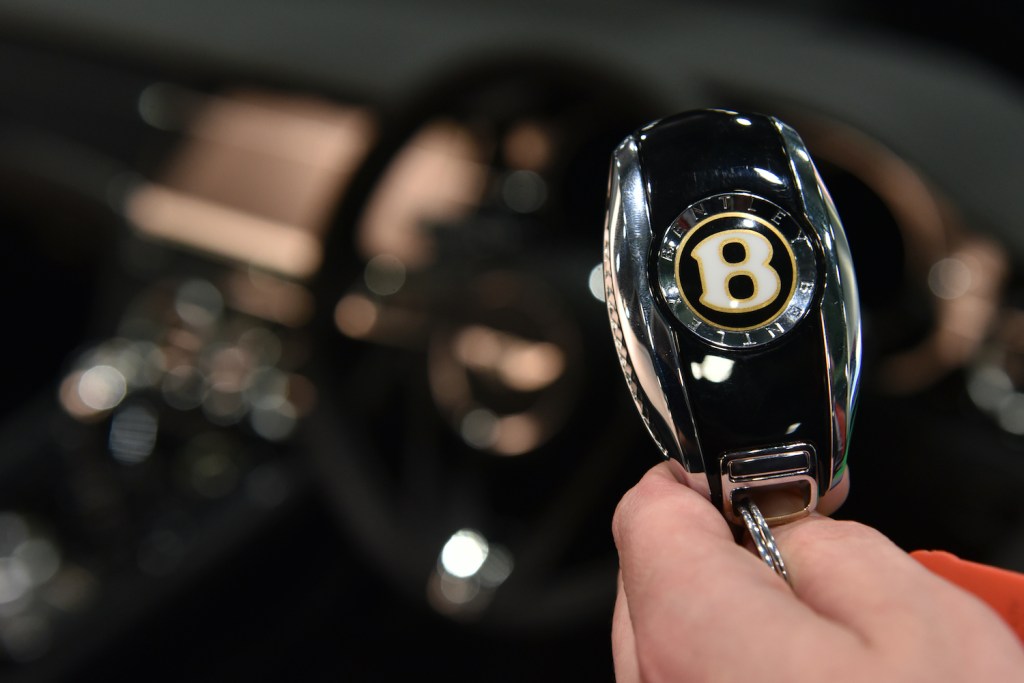 A Bentley key fob in someone's hand