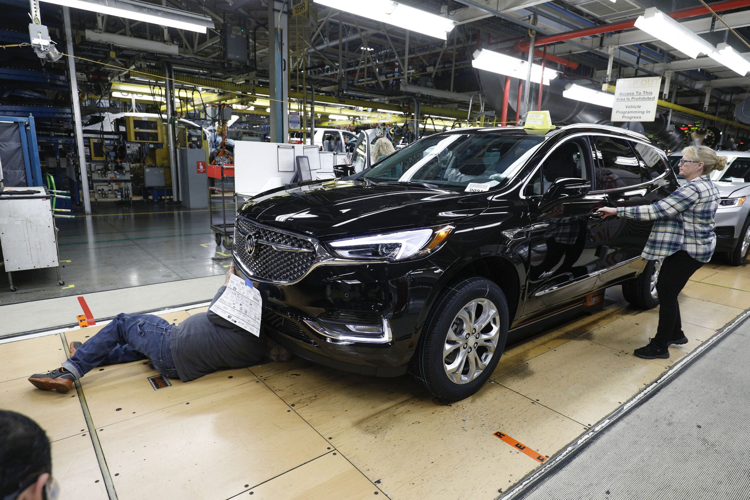 General Motors workers are shown in the Quality Department area of the assembly line at the General Motors Lansing Delta Township Assembly Plant