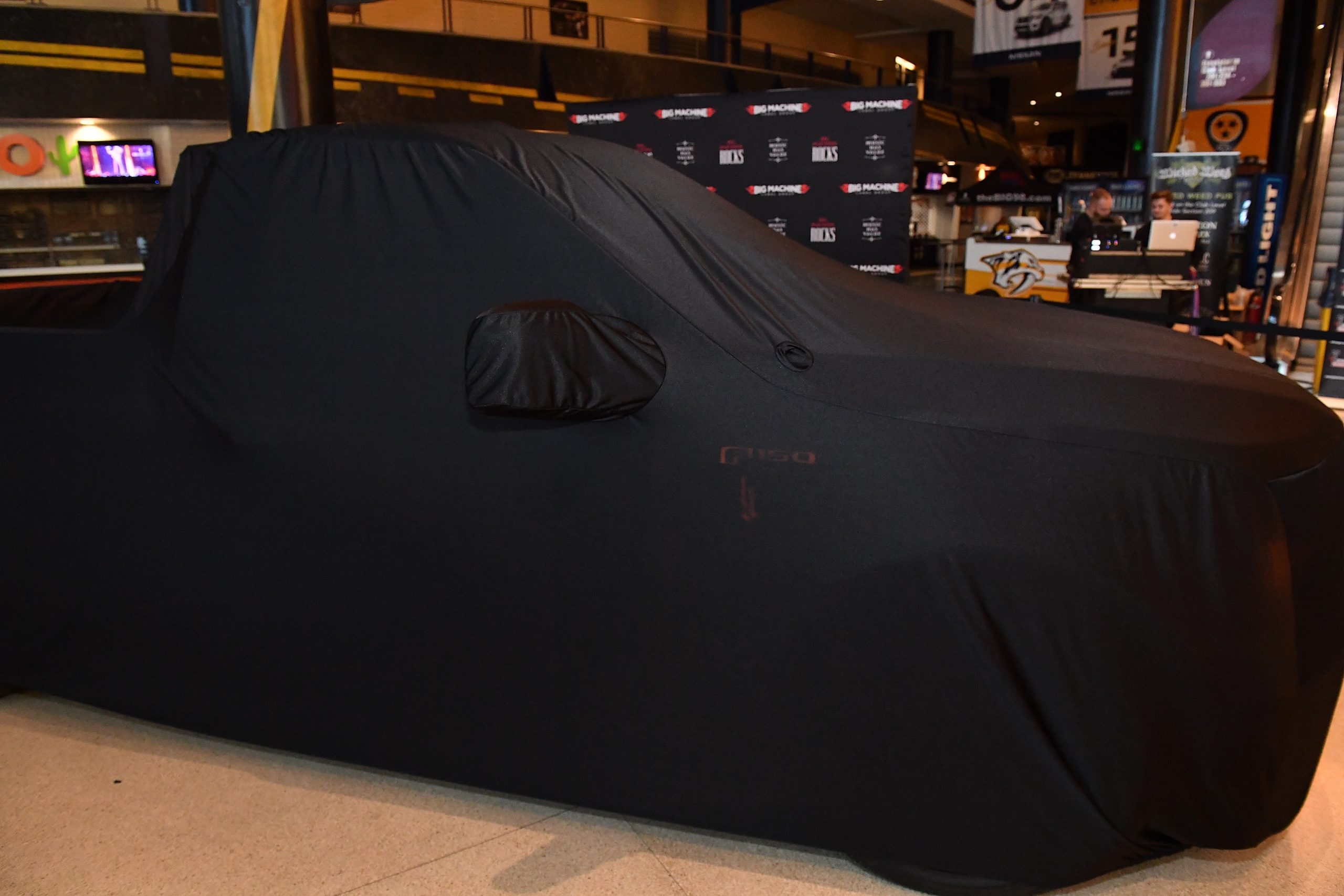 Brantley Gilbert's Speedcore Ford F150 is held under a car cover before unveiling at Bridgestone Arena Plaza