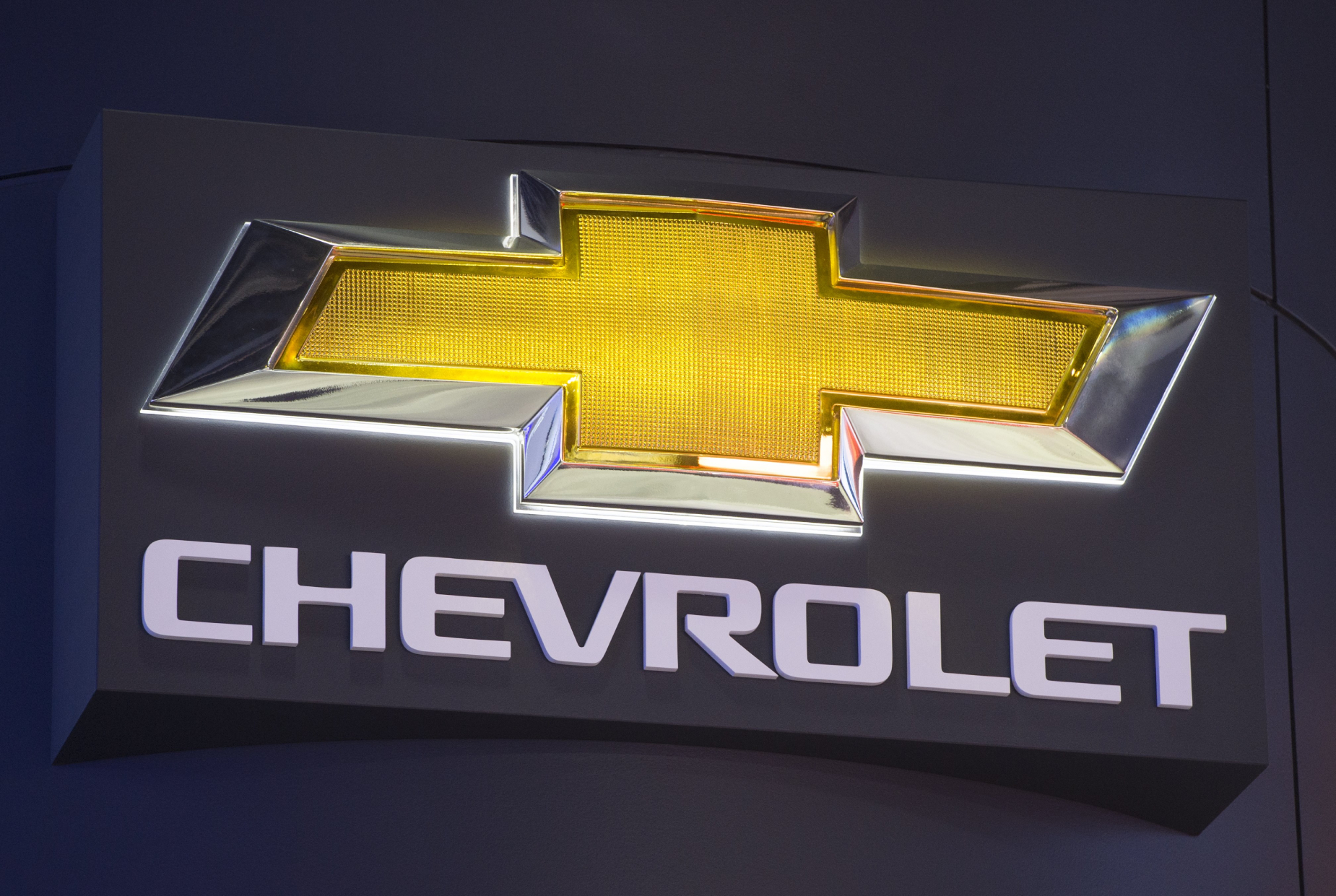 A close-up of Chevy's bowtie logo with a black background