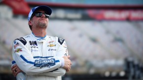 Dale Earnhardt Jr. looks to the sky with his arms folded