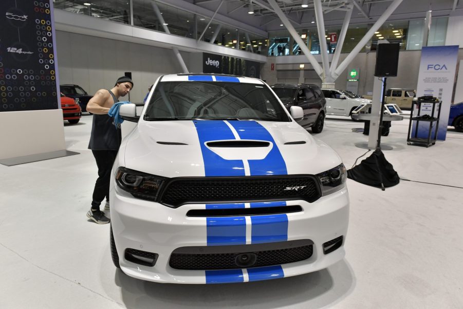 A worker readies a Dodge Durango SRT for exhibit at the 2020 New England Auto Show Press Preview