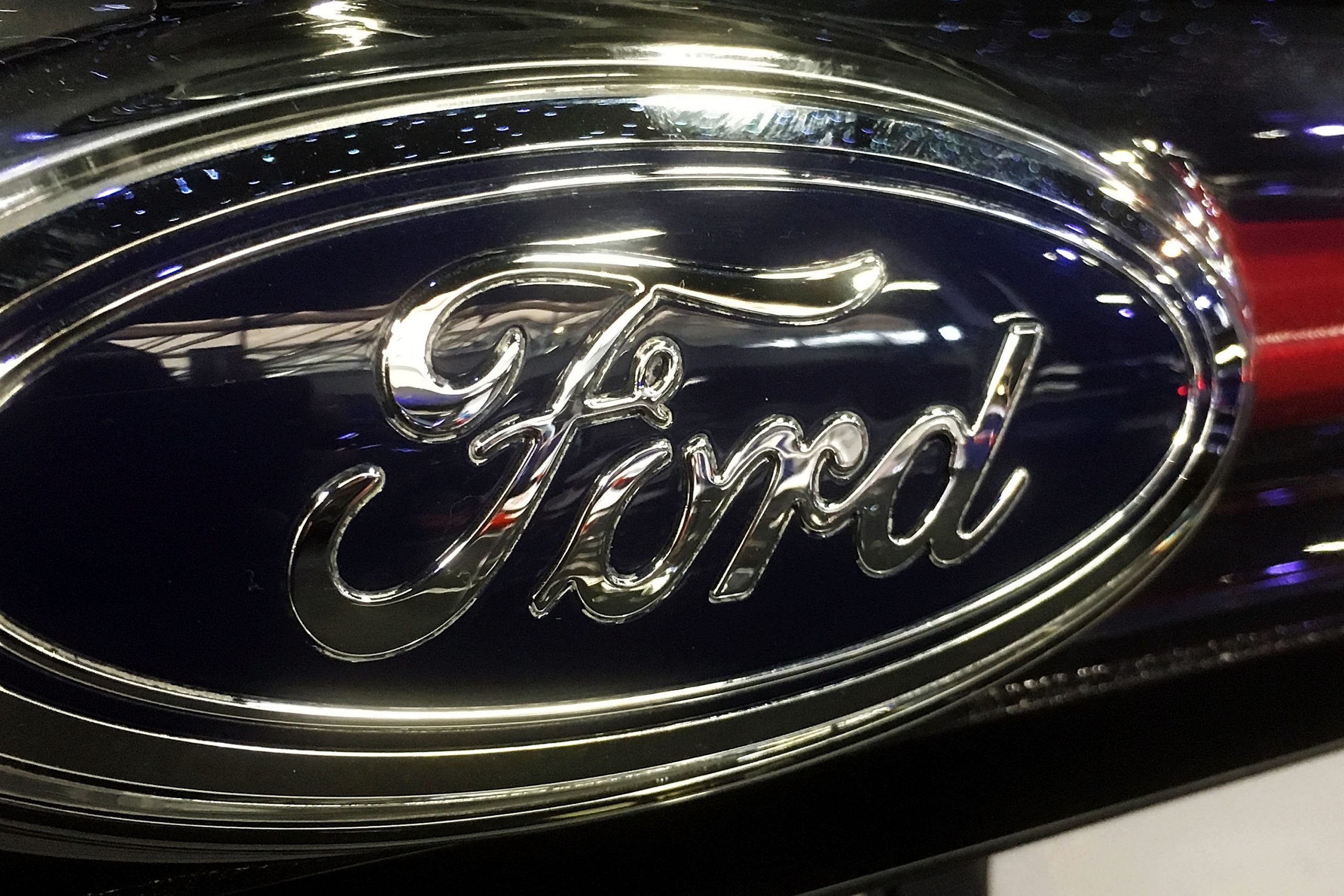The Ford logo badge adorns a Ford car during the 2016 London Motor Show. The 2022 Ford Maverick is set to don the same badge next year