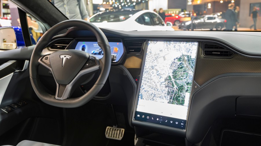 An image of a Tesla infotainment screen at an auto show.