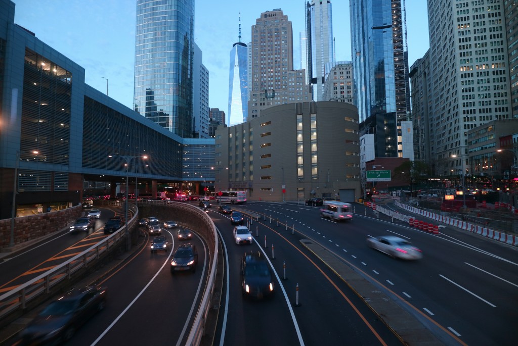 An image of several cars in traffic on a highway.