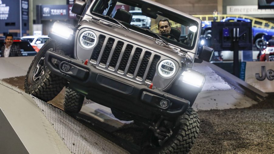 A staff member demonstrates a 2021 Jeep Gladiator at the 2020 Chicago Auto Show Media Preview