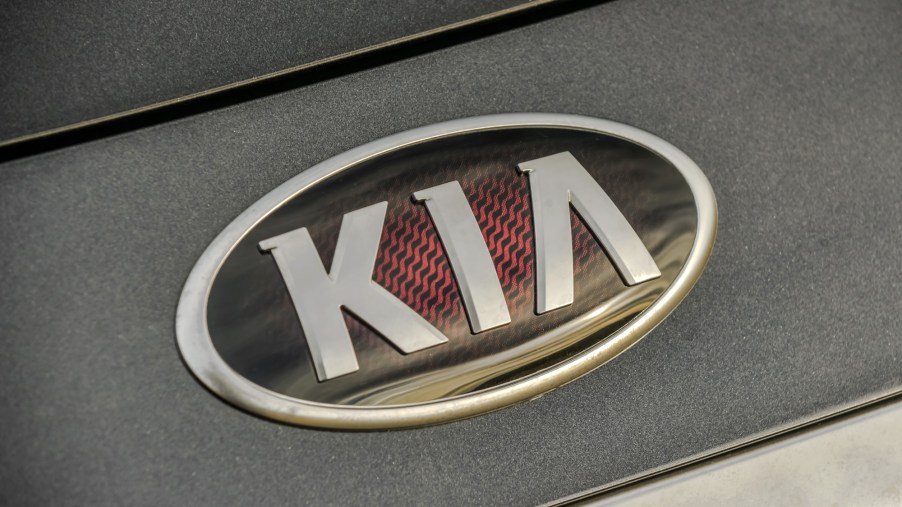 A close-up look at the Kia Logo on a black 2020 Kia K900