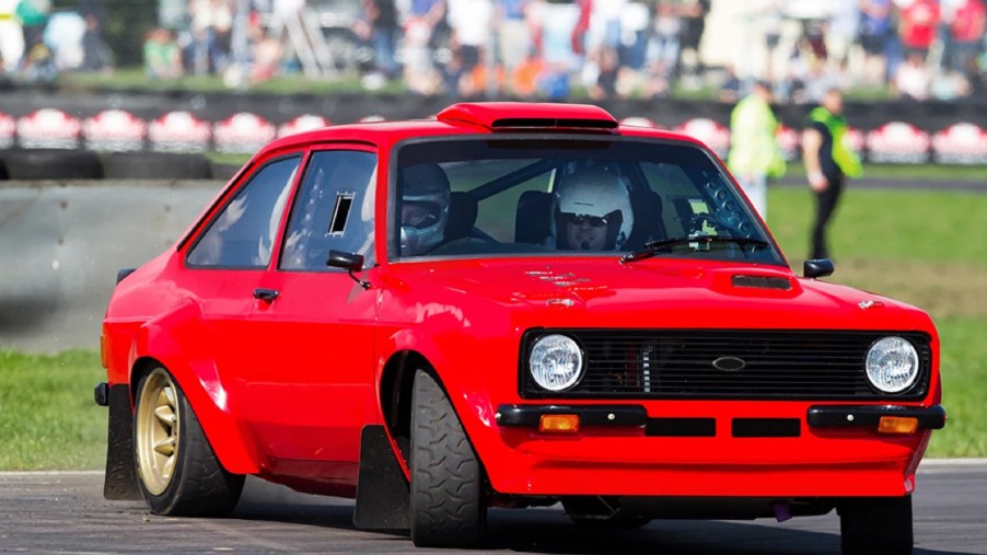 A red MST Mk2 Ford Escort Ultimate Rally Car drifts around a racetrack